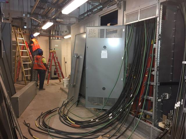 Electricians pulling power cable