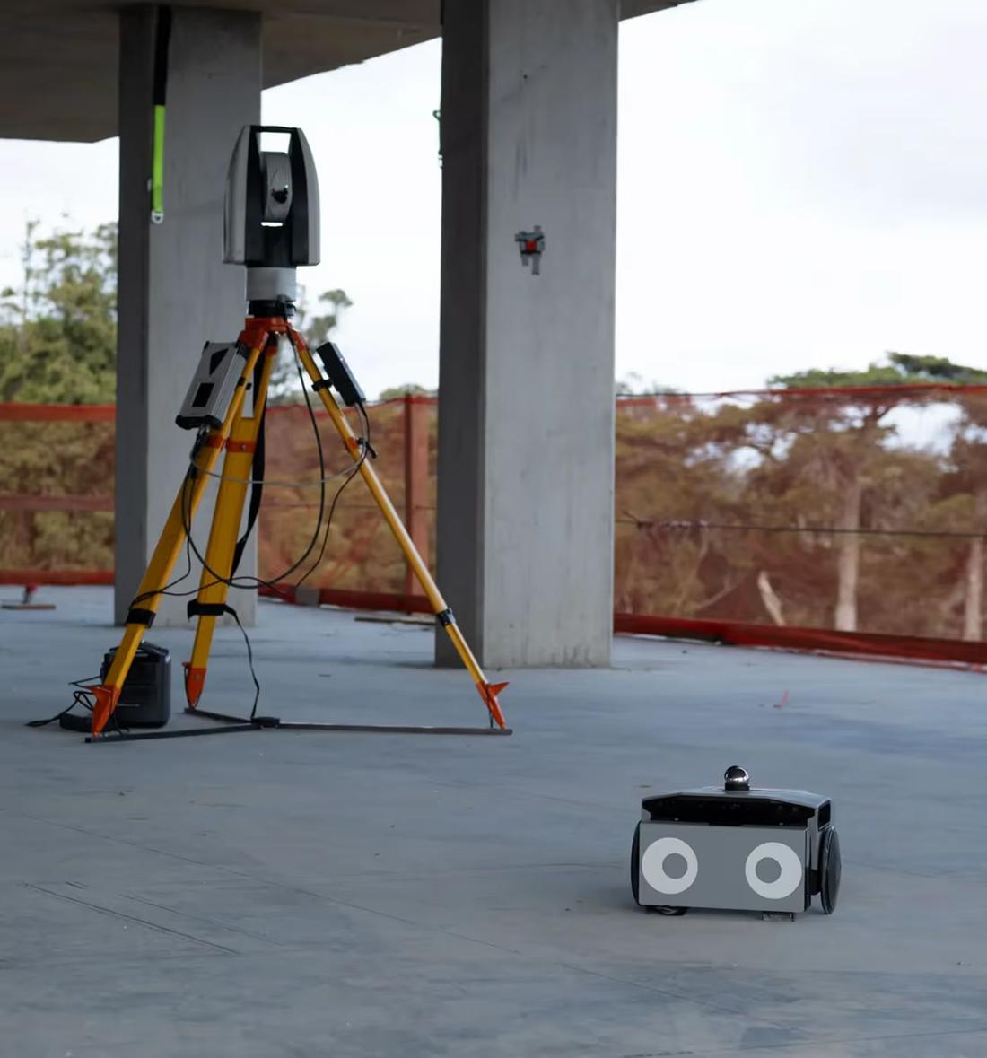 FieldPrinter beside a total station. Where: Construction site concrete deck (not stated)