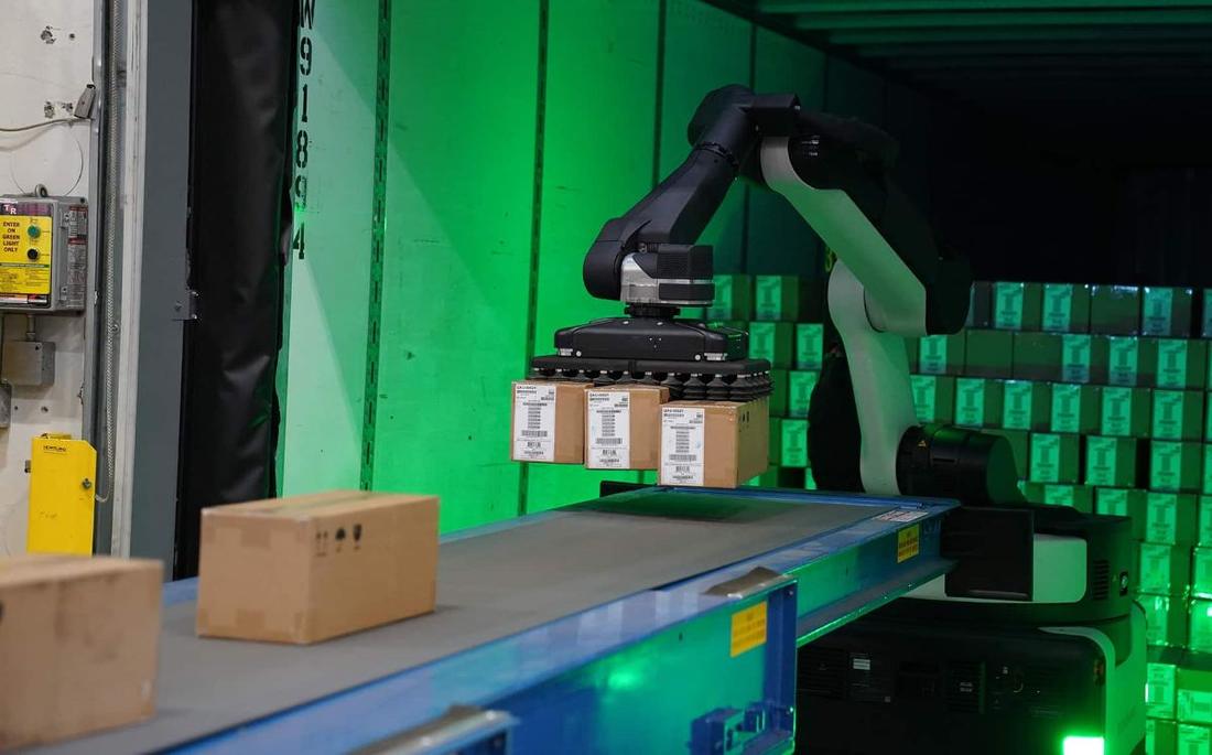 Stretch moving cartons at a dock door. Where: Warehouse loading dock (not stated).