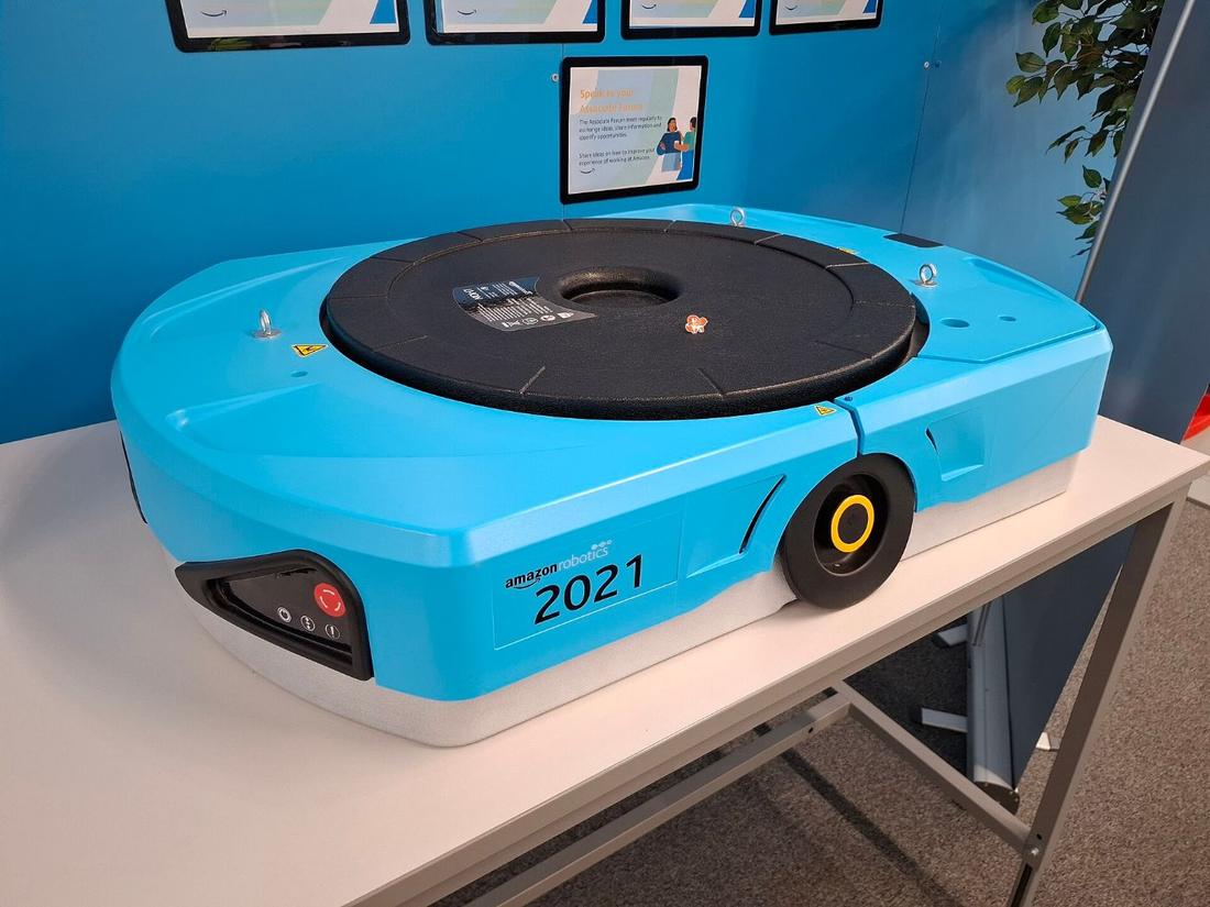 Amazon Robotics drive unit on a display table. Where: Amazon fulfilment centre, Swindon, UK (per Commons title).