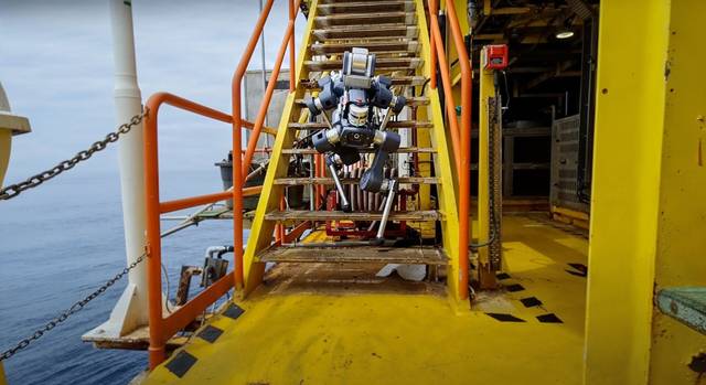 ANYmal X on an offshore platform stairway.