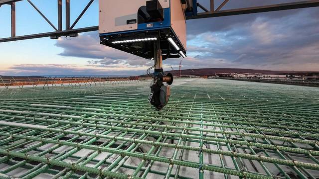 TyBot tying head above a rebar mat.